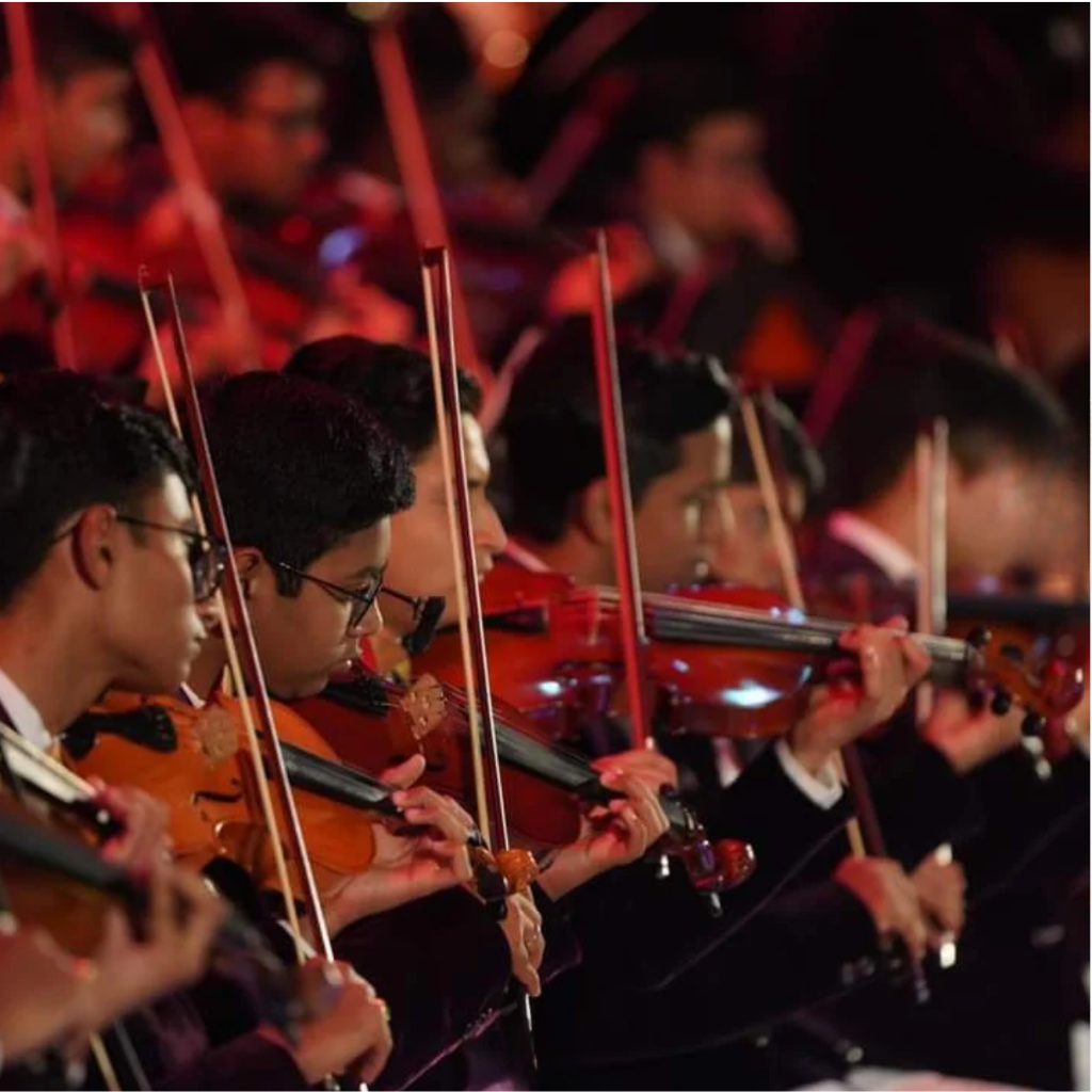 Young musicians from the student symphony orchestra performing on stage